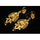 A PAIR OF FILIGREE DROP EARRINGS. Double-sided drops of intricate scrolling and floral filigree
