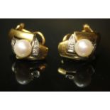 A PAIR OF 18CT GOLD, DIAMOND AND CULTURED PEARL EARRINGS Each earring with a single pearl flanked by