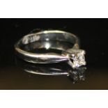 AN 18CT WHITE GOLD AND DIAMOND SOLITAIRE RING With single princess cut stone mounted on a four prong