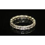 A DIAMOND FULL ETERNITY RING. Circular-cut diamonds claw set in white metal. Estimated total diamond