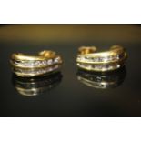 A PAIR OF 18CT GOLD AND DIAMOND EARRINGS Each having and arrangement of twelve round cut diamonds