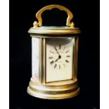 ELLIOTT AND SONS,AN EARLY 20th CENTURY GILT BRASS AND ENAMEL CYLINDRICAL CARRIAGE CLOCK, having