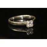 A 9CT WHITE GOLD AND DIAMOND SOLITAIRE RING With a single princess cut stone set in an eight pong