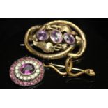 THREE VICTORIAN BROOCHES. A hollow, gilt metal and amethyst-set knot brooch (5cm long), a small,