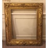 A GOOD EARLY 19TH CENTURY GILT WOOD AND GESSO PICTURE FRAME, heavily decorated with flora 104 x