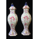 A FINE PAIR OF YONGZHENG 'FAMILLE-ROSE' VASES AND COVERS OF SLENDER BALUSTER FORM, The sides moulded
