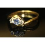 AN 18CT GOLD, DIAMOND AND SAPPHIRE THREE STONE RING Having a single round cut sapphire flanked by