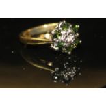 AN 18CT, DIAMOND AND TOURMALINE DAISY CLUSTER RING With an arrangement of six tourmaline stones