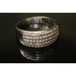 An 18ct WHITE GOLD AND DIAMOND HALF ETERNITY RING, having five single rows of channel set diamonds