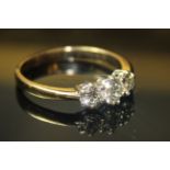 An 18ct WHITE GOLD AND DIAMOND THREE STONE RING, three round cut graduating diamonds held in a plain