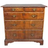 AN 18TH CENTURY WALNUT CHEST , with two short above three long drawers fitted with brass handles and