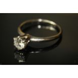 A WHITE METAL AND DIAMOND SOLITAIRE RING, having a single round cut diamond held in a four prong