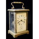 A 20th CENTURY GILT BRASS CARRIAGE CLOCK, having four bevelled glass panels and subsidiary dial.