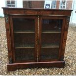 A VICTORIAN WALNUT CABINET The satin inlaid frieze with foliate scroll motifs over gilt metal