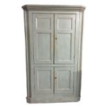 A 19TH CENTURY CONTINENTAL FLOOR STANDING CORNER CABINET, the four panelled doors enclosing a