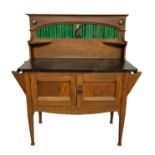 AN EDWARDIAN ART NOUVEAU STYLE OAK DRESSING TABLE AND MATCHING WASHSTAND With an arched top mirror