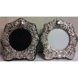 A PAIR OF SILVER STRUT PICTURE FRAMES With relief decoration of cherubs. (18cm x 16cm)