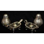 A PAIR OF VINTAGE ITALIAN SILVER SALT AND PEPPER OVOID SHAKERS With Rococo style embossed