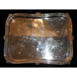 AN EDWARDIAN SILVER RECTANGULAR SERVING TRAY Cast in relief with floral decoration to outer edge,
