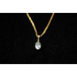A 20TH CENTURY 9CT GOLD AND TOPAZ PENDANT Having a single oval cut stone collet set and suspended