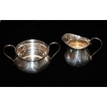 AN EARLY 20TH CENTURY PLAIN SILVER SUGAR BASIN AND CREAM JUG Hallmarked Birmingham, 1922.