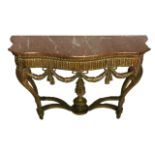 AN 18TH CENTURY DESIGN CARVED GILTWOOD SERPENTINE CONSOLE TABLE The red marble top over carved egg