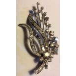 A VINTAGE PLATINUM AND DIAMOND BROOCH The arrangement of round and baguette cut diamonds forming a