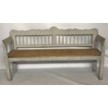 A 19TH CENTURY SWEDISH PAINTED AND DISTRESSED BENCH With railed serpentine backrest. (h 103cm x w