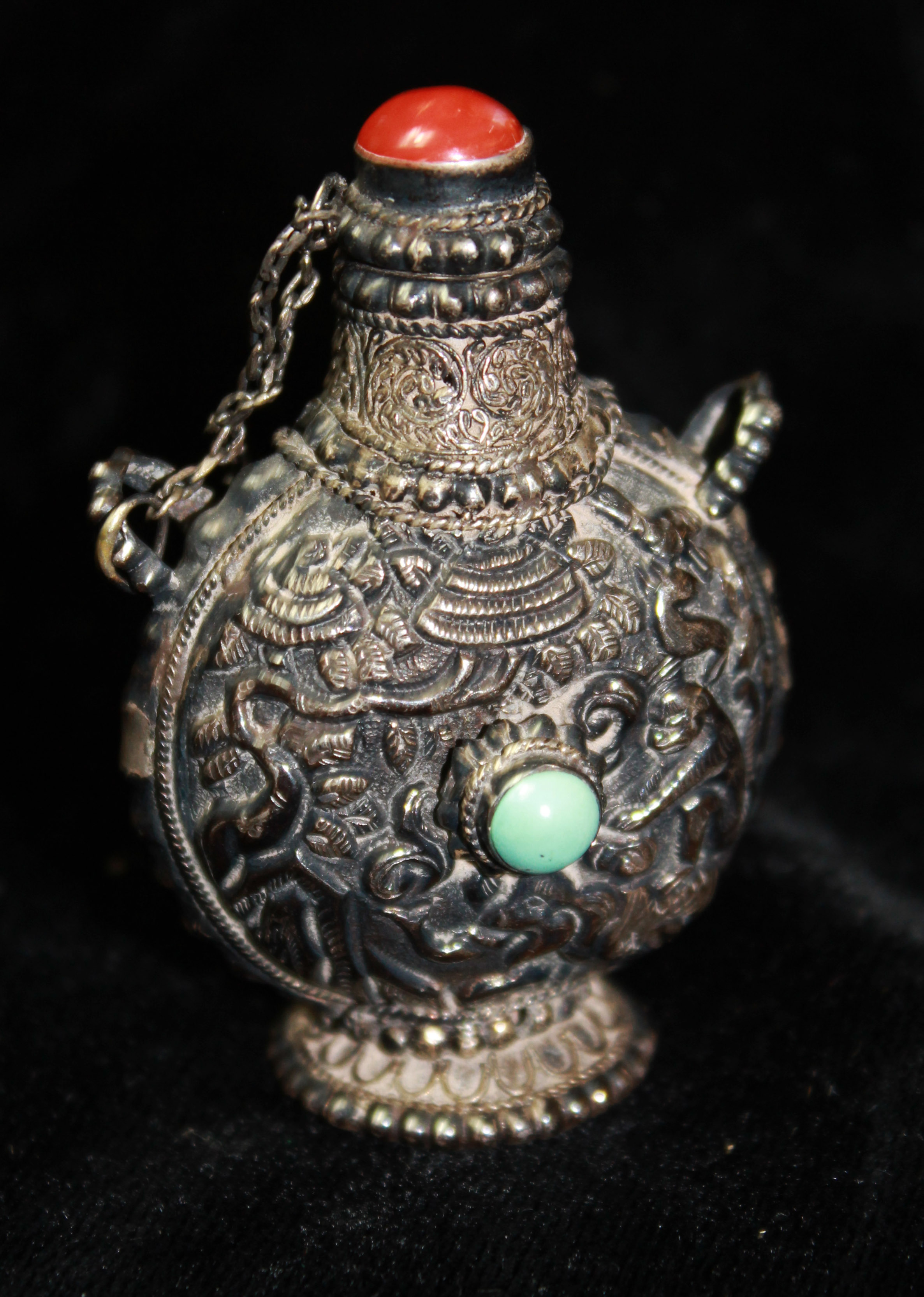 AN ANTIQUE CHINESE SILVER, CORAL AND TURQUOISE SNUFF BOTTLE Of baluster form with cabochon cut coral