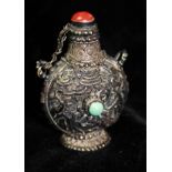 AN ANTIQUE CHINESE SILVER, CORAL AND TURQUOISE SNUFF BOTTLE Of baluster form with cabochon cut coral
