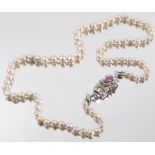 A 9CT GOLD AND RUBY GRADUATED PEARL NECKLACE Set with eighty pearls of approximately 3.5mm - 6mm,