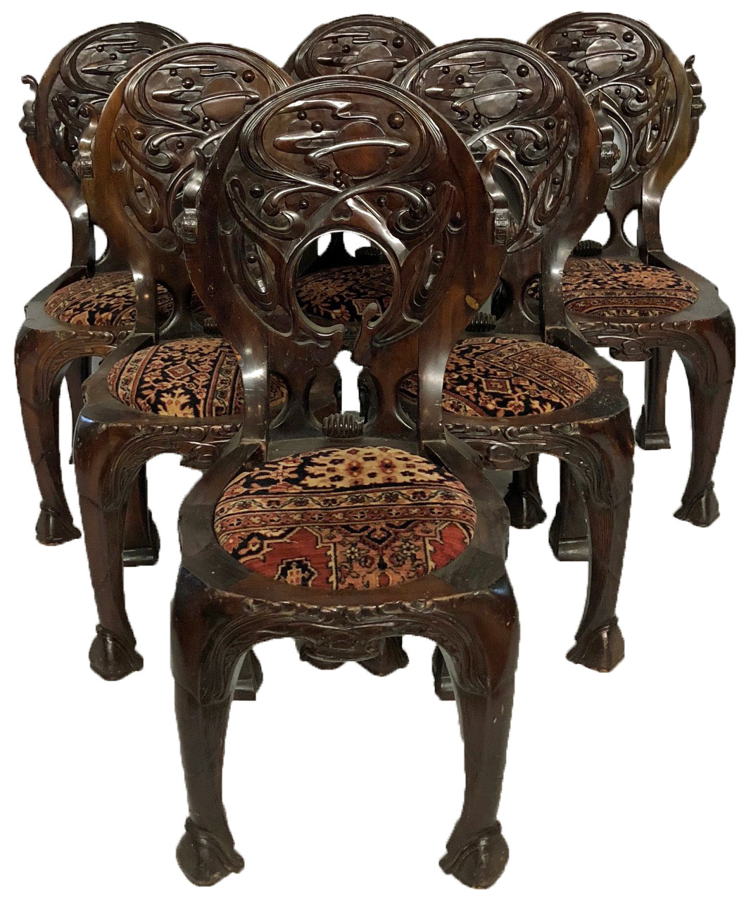 AN UNUSUAL SET OF SIX 20TH CENTURY CARVED HARDWOOD ORGANIC FORM CHAIRS The backs caved with orbiting