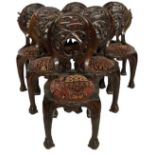 AN UNUSUAL SET OF SIX 20TH CENTURY CARVED HARDWOOD ORGANIC FORM CHAIRS The backs caved with orbiting