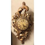 AN EARLY 20TH CENTURY GILTWOOD AND GESSO CARTEL WALL CLOCK Carved with scrolling foliage and