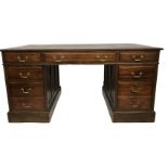 AN EDWARDIAN MAHOGANY PEDESTAL DESK With blue tooled leather writing surface above arrangement of