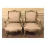 A PAIR OF LATE 19TH CENTURY FRENCH OPEN ARMCHAIRS With painted and decorated frames, in oatmeal
