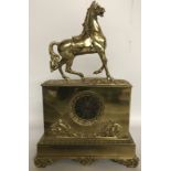 A 19TH CENTURY EMPIRE DESIGN MANTLE CLOCK Surmounted with a horse.