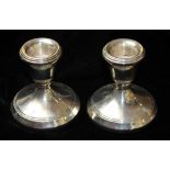 A PAIR OF 20TH CENTURY SILVER SQUAT FORM CANDLESTICKS Of plain design with circular bases,