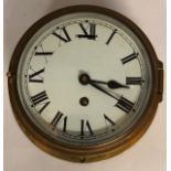 A BRASS CASED SHIP'S BULKHEAD CLOCK With Roman numerals. (circumference 20.5cm)