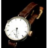 AN EARLY 20TH CENTURY SILVER TRENCH STYLE GENT'S WRISTWATCH Having a circular white dial with