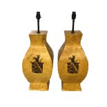 A PAIR OF PAINTED AND DISTRESSED TOLEWARE LAMPS Decorated with armorial crests. (h 62cm x d 23cm x w