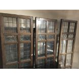 A SET OF THREE LARGE EDWARDIAN COPPER GLASS PANELLED ROOM DIVIDERS. (h 257cm x w 59cm)