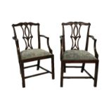 A PAIR OF 19TH CENTURY MAHONGANY CHIPPENDALE DESIGN ARMCHAIRS The scrolling carved and pierced backs