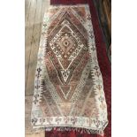 AN ANTIQUE PERSIAN WOOLLEN RUNNER RUG Cream ground with large lozenge design to central field with