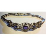 AN UNUSUAL WHITE METAL, AMETHYST AND SAPPHIRE BRACELET Set with a central oval cut amethyst, flanked