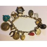 AN EARLY 20TH CENTURY 9CT GOLD BRACELET Having spherical links set with various charms including