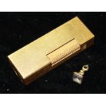 DUNHILL, A VINTAGE GOLD PLATED RECTANGULAR LIGHTER With engine turned decoration, together with a