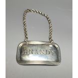 GEORGE UNITE, AN EARLY VICTORIAN SILVER DECANTER LABEL 'Brandy', hallmarks 'Birmingham, 1844, G.U.'.