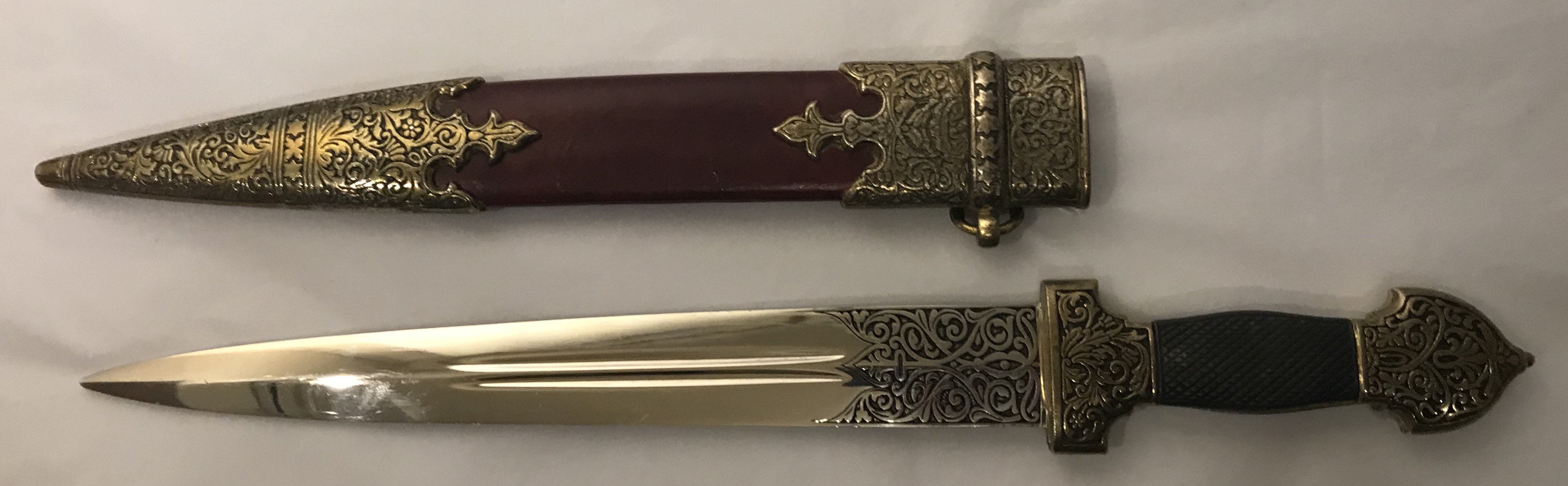 A 20TH CENTURY STEEL DRESS DAGGER Having a cast decorative handle and black grip, steel blade and