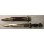 A 20TH CENTURY STEEL DRESS DAGGER Having a cast decorative handle and black grip, steel blade and